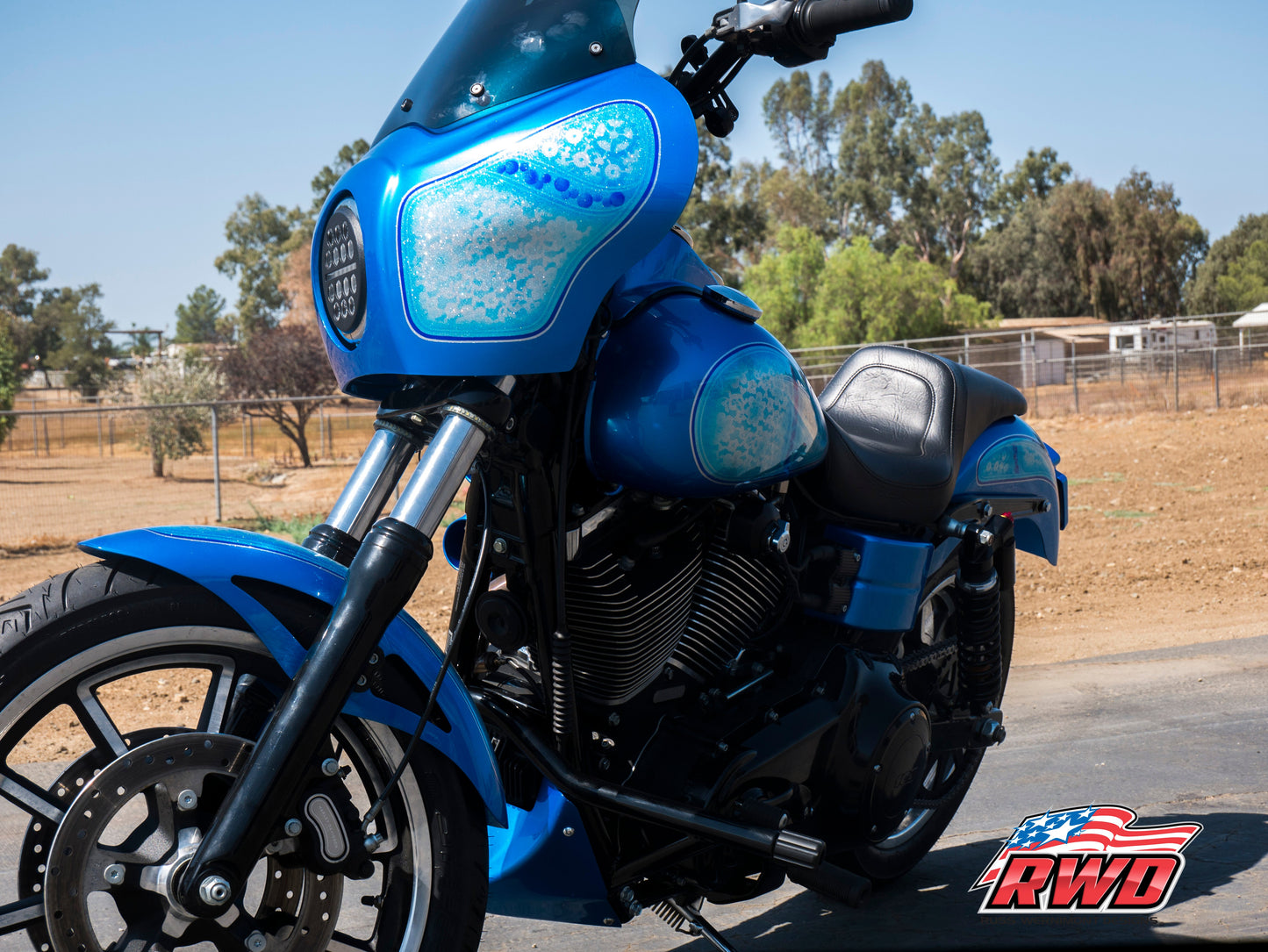 RWD V-Twin parts installed on a custom Harley Davidson motorcycle parked on pavement