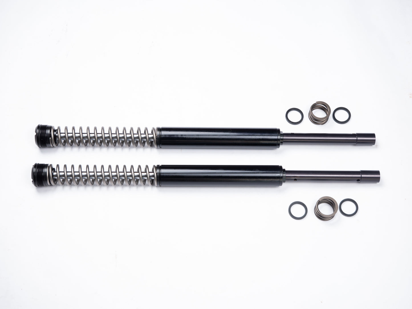 Parts of the RWD RS-1F softail front fork cartridge system laid out on a white background